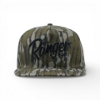 Front view of a Mossy Oak Bottomland camo hat with the word ‘Ranger’ embroidered in large black lettering