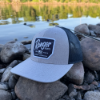 Ranger Patch Cap on rocks next to fishing pole